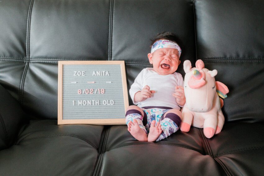 Crying baby in a cute floral outfit