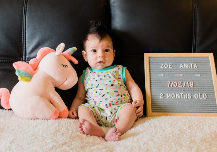 A baby in a bright romper