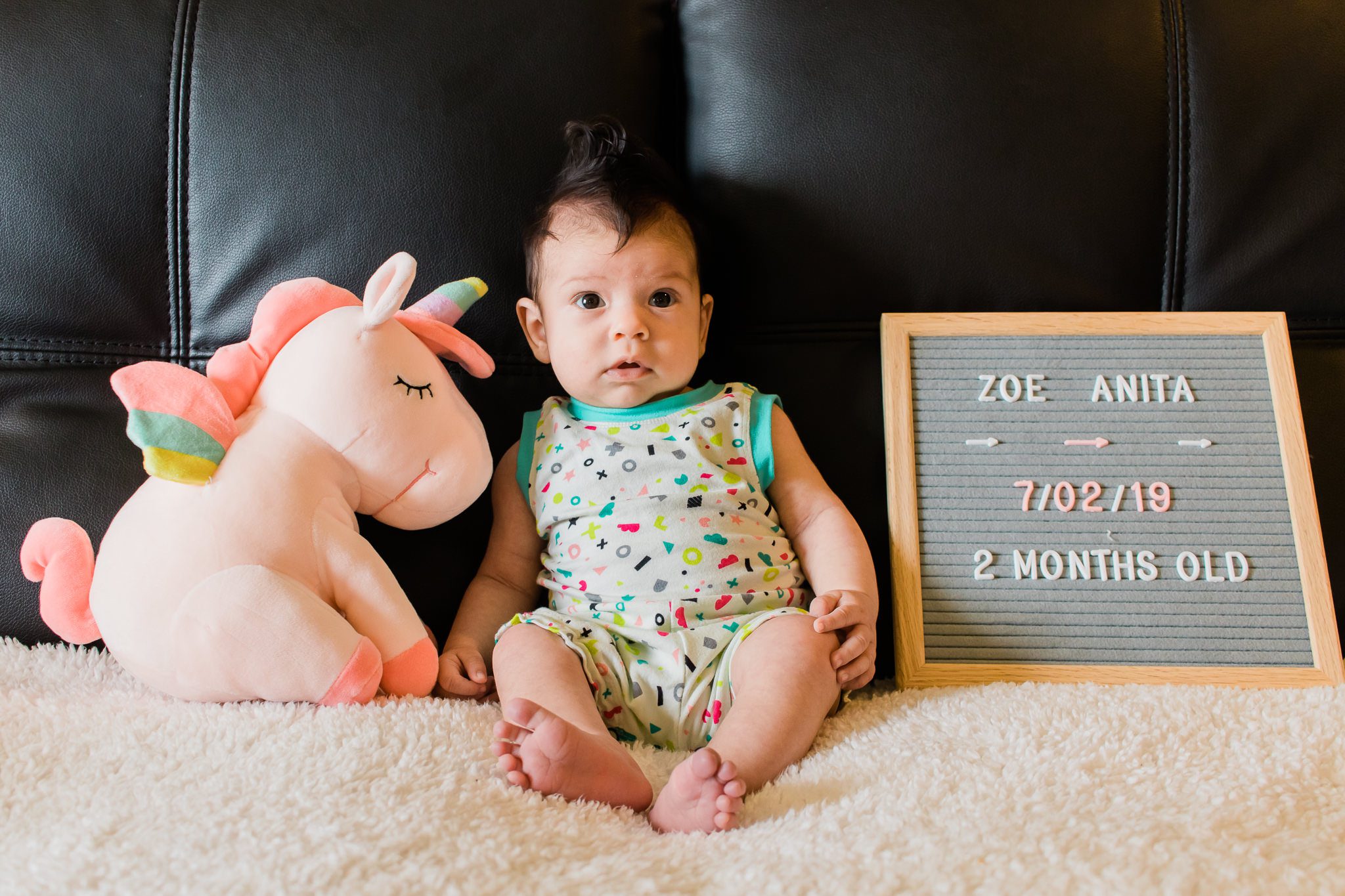A baby in a bright romper