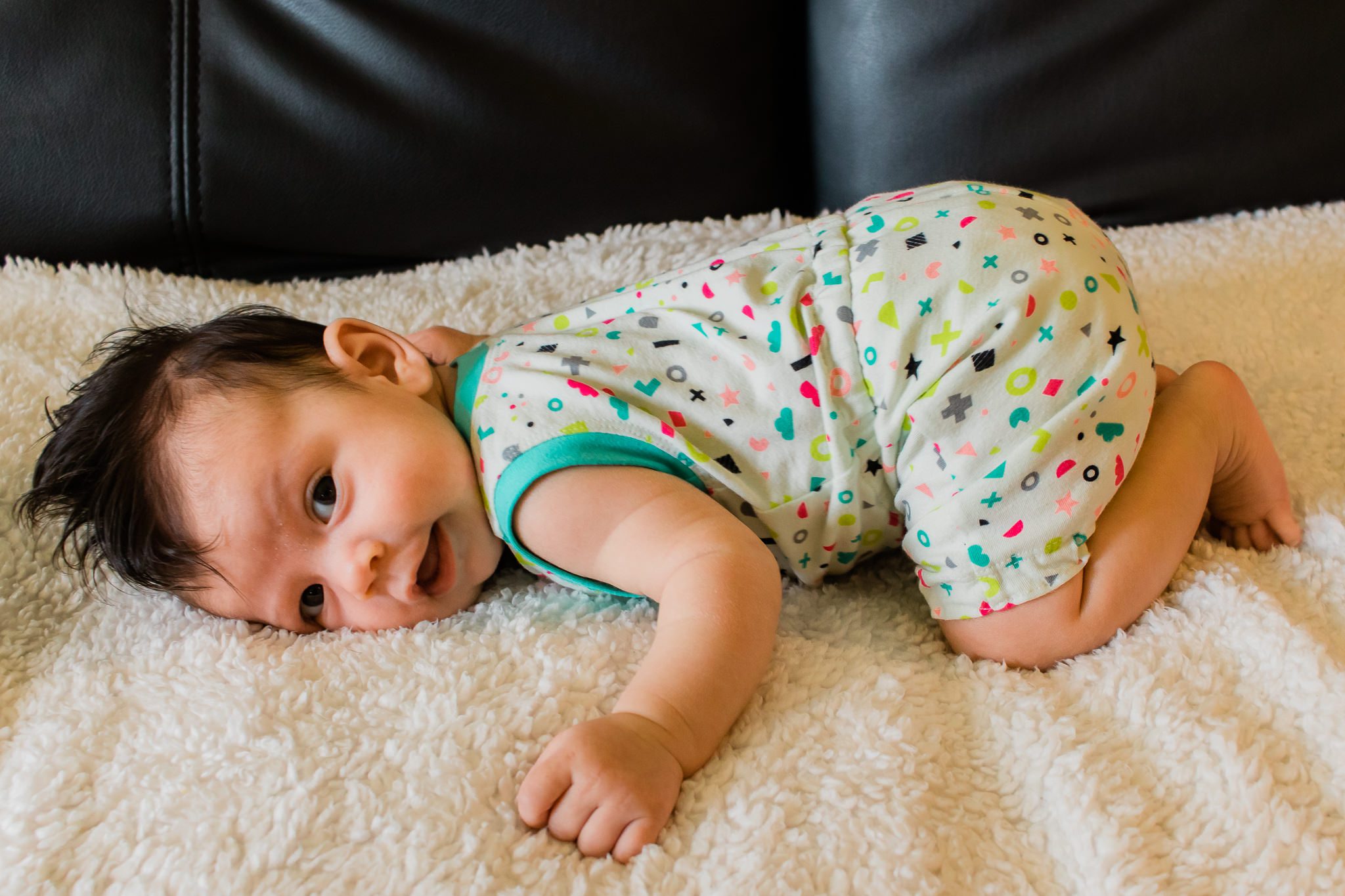 A baby in a bright romper