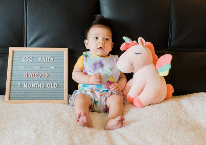 3 month old in popsicle overalls and mustard shirt