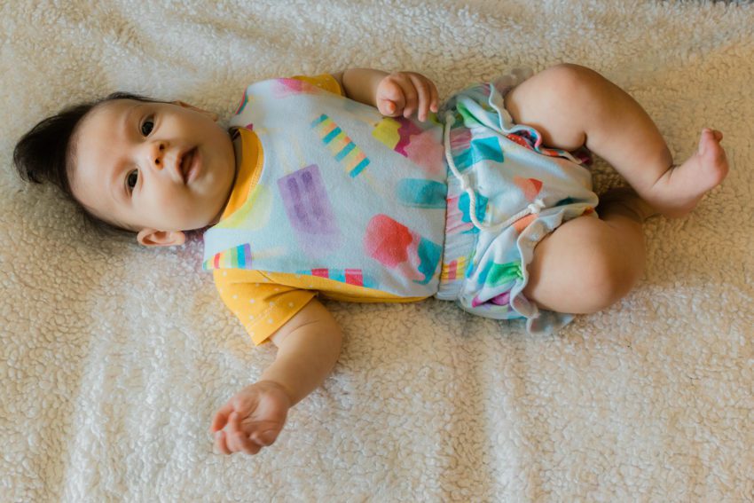 3 month old in popsicle overalls and mustard shirt