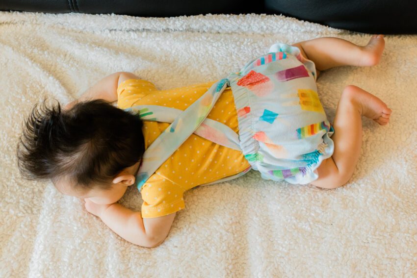 3 month old in popsicle overalls and mustard shirt